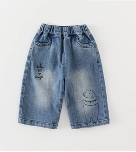 Close-up of kids light blue denim pants with elastic waist and cute bear embroidery