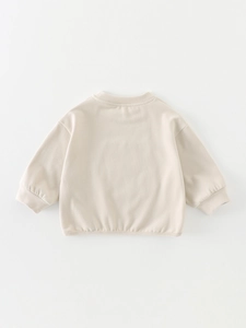 Kids long sleeve beige sweatshirt featuring a crew neck and ribbed cuffs for autumn wear
