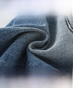 Detailed macro view of high-density soft blue denim fabric with washed texture