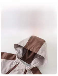 Detail of color-block hooded jacket for baby boys with smooth fabric and secure zipper