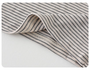 Detailed close-up of the fine rib knit texture and precision overlock stitching on stripes