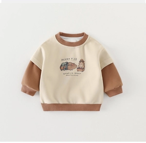 Detail of baby sweatshirt featuring a guinea pig print and brown ribbed contrast cuffs