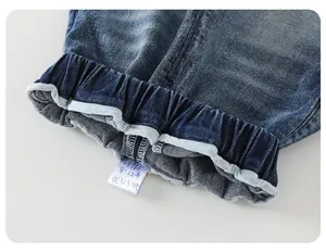 Macro shot of children's blue washed denim jeans with an elastic waistband and neat stitching