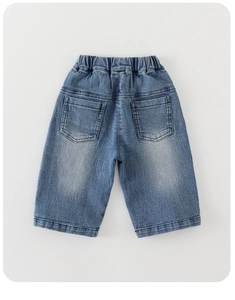 Detail view of elastic waistband and back pockets on light wash cotton denim pants for kids