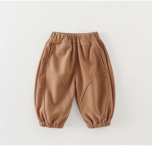 Detail of tan cotton toddler jogger pants with elastic waist and curved stitching