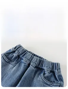 Detail view of boys' denim jeans featuring elastic waistband and functional side pockets