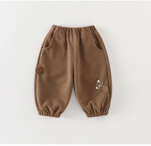 Detail view of brown toddler jogger pants featuring soft cotton fabric and a cute bear print