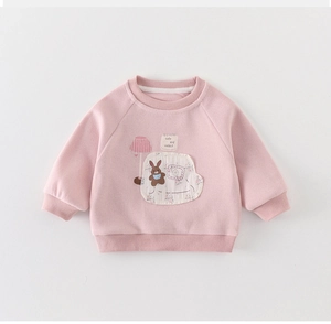 Close-up of pink cotton sweatshirt featuring cute rabbit applique and ribbed details