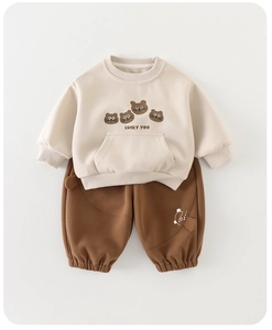 Detailed flat lay of toddler beige sweatshirt with bear print and brown joggers set