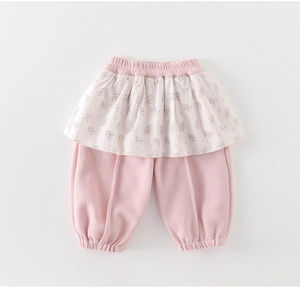 Detailed close-up of girls' pink floral ruffled skirt leggings with elastic waistband