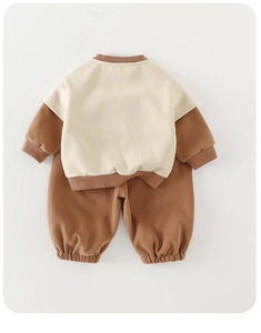 Flat lay of baby two-piece tracksuit with color-block sweatshirt and joggers