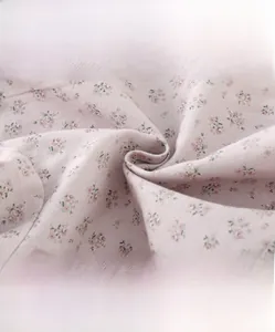 Close-up of soft pink floral cotton fabric with high-density weave for baby clothes