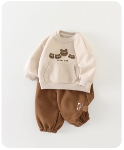 Detail of baby sweatshirt and pants set featuring cute bear ears on the side pocket