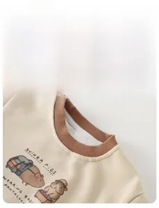 Detail of the brown ribbed neckline and cute guinea pig print on infant sweatshirt