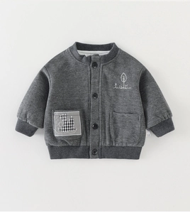 Detailed view of quilted texture on grey boy's jacket with white plant embroidery