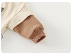 Detail of ribbed cuffs on baby cotton sweatshirt with clean seams and contrast sleeves