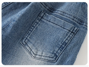 Detail macro shot of denim pocket with high-quality stitching and blue wash texture