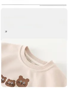 Close-up of baby sweatshirt showing ribbed neckline and cute brown bear prints