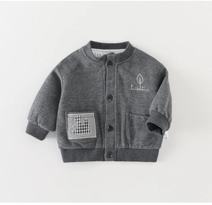 Detail of grey knitted boys jacket featuring bird patch and tree embroidery textures