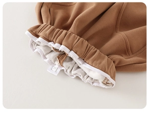 Detail of baby joggers with elastic waistband and soft knit lining in caramel brown