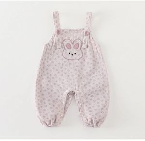 Detail of pink floral baby romper featuring cute rabbit embroidery and button straps