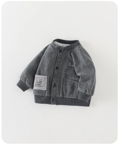 Detailed close-up of dark grey waffle knit cardigan for boys with cartoon patch and buttons