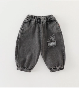 Detail view of elastic waistband and embroidered patch on dark grey boys joggers