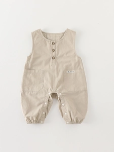 Neutral beige baby overalls romper made of cotton linen with wooden buttons and pockets