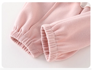 Detail shot of the ribbed pink knit cuffs and soft striped texture on this girls' set