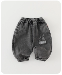 Close-up of boys deep grey washed denim pants with elastic waistband and embroidery