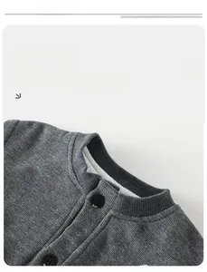 Detail shot of grey waffle knit cotton jacket showing ribbed collar and dark buttons