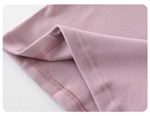 Detailed macro view of the double-needle stitching and inner hem on purple knit fabric