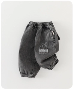 Close-up of elastic waistband and cargo pocket with house embroidery on kids jogger jeans