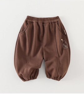 Close-up of kids dark brown knit joggers featuring elastic waist and house embroidery