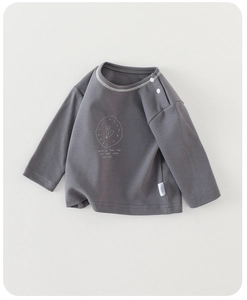 Detail of dark grey infant long sleeve shirt with soft cotton texture and shoulder snaps