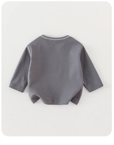 Detail view of cotton knitted long sleeve t-shirt showing neck stitching and soft fabric