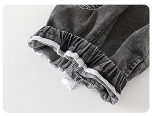 Detail of dark grey kids jeans featuring elastic waistband and soft white cotton lining