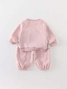 Pink ribbed knit toddler tracksuit featuring a crewneck sweatshirt and matching joggers