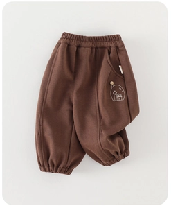 Close-up of brown fleece-lined kids pants with white house embroidery and elastic waist