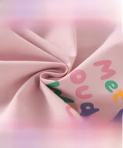 Detail of pink cotton fabric with artistic prints featuring soft and breathable texture