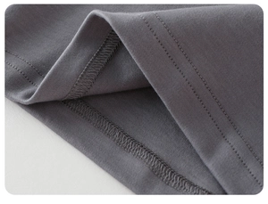 Detailed close-up showing double-stitched hem and gray knit fabric texture of the t-shirt