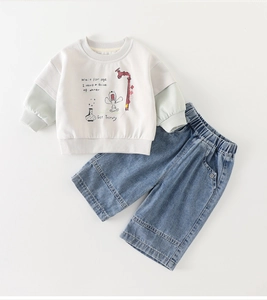 Detailed flat lay of toddler sweatshirt with cartoon print and blue denim wide-leg pants