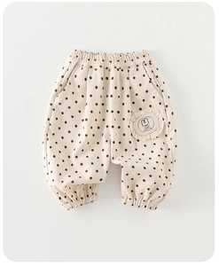 Detail of beige polka dot kids' pants with elastic hem and Happy rabbit lace embroidery