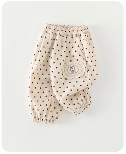 Detail of toddler beige polka dot pants featuring a cute rabbit lace patch and elastic cuffs