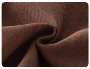 Close-up of high-density knit fabric in deep brown showing texture and soft drape