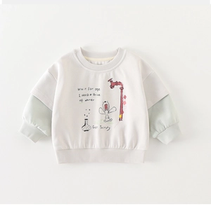 Detail of child sweatshirt showing ribbed cuffs and cartoon print on soft fabric