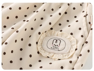 Close-up of baby polka dot pants showing lace patch with rabbit and HAPPY embroidery