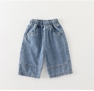 Detailed view of kids denim shorts featuring elastic waist and wash blue fabric texture