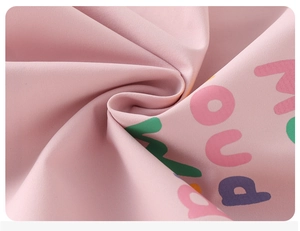 Macro view of pink waterproof fabric with colorful letter prints for kids jacket