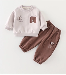 Detail of toddler sweatshirt with GO! print and sweatpants featuring a 3D puppy pocket